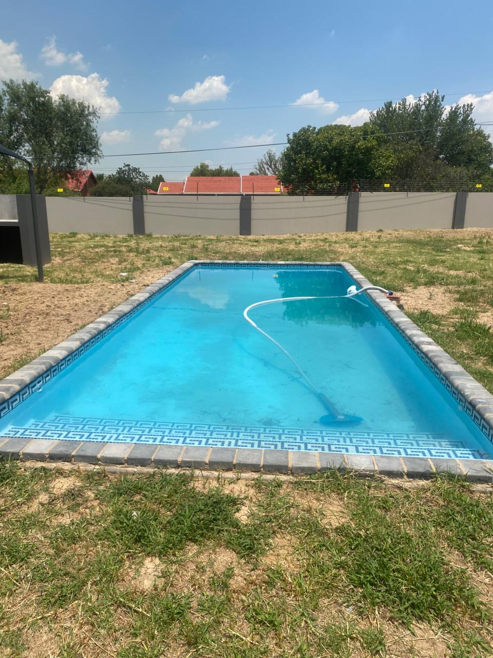 Greek-key mosaic rectangular pool